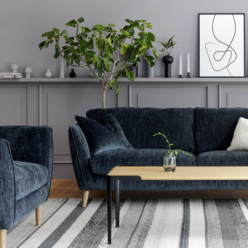 sits stella sofa 3 seater in atropa dark blue fabric. lifestyle image showing wood angled leg.