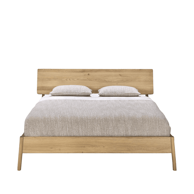 Oak double bed with grey cushions and bed spread
