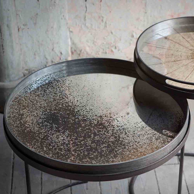 large mirrored tray with aged effect on metal circular table