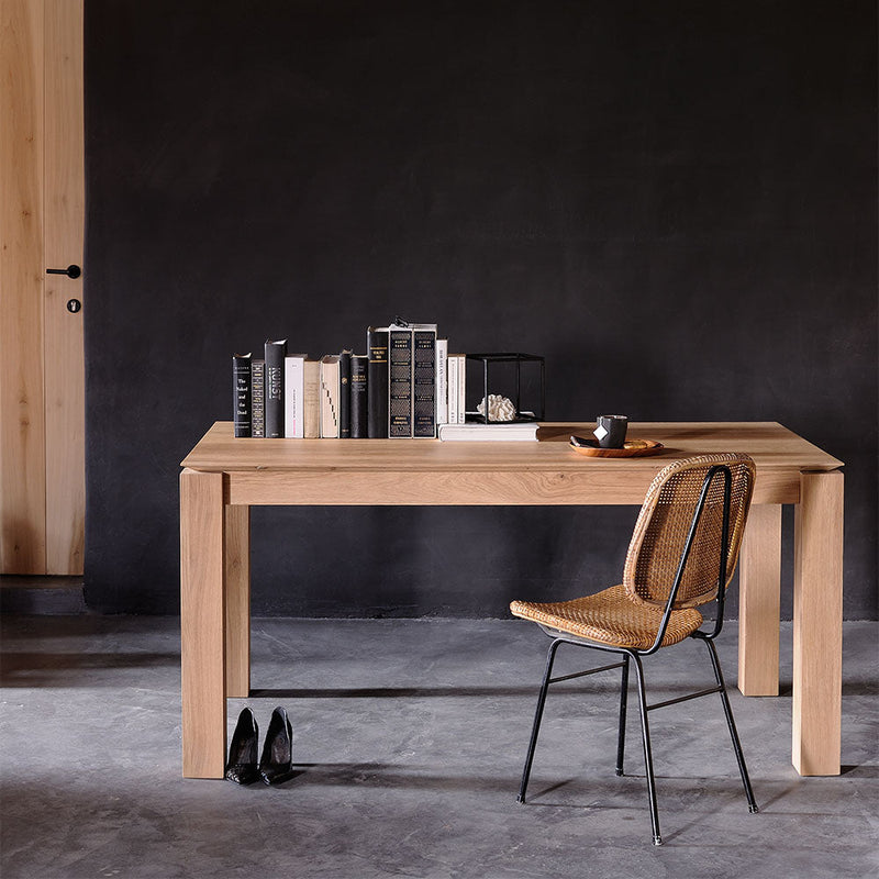 Oak planar table, shown closed, styled with books and a chair as a desk