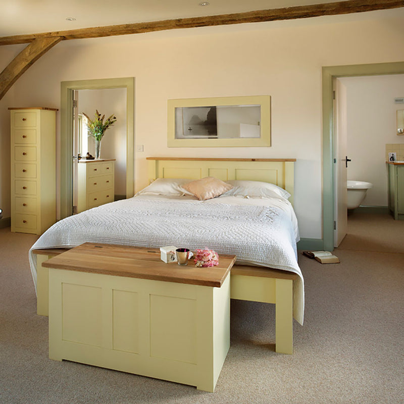 Provence blanket box pained cream with a oak top, shown at the end of a provence bed . 