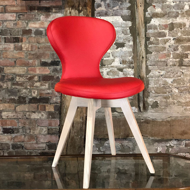 R1 leather dining chair with oak legs, shown in red 