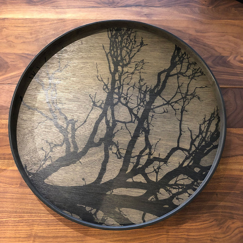 Large round black tray with silhouette of a black tree and branches