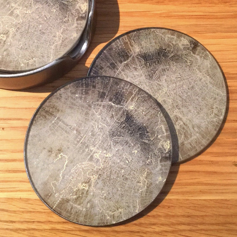 altas coasters laid on wooden table top