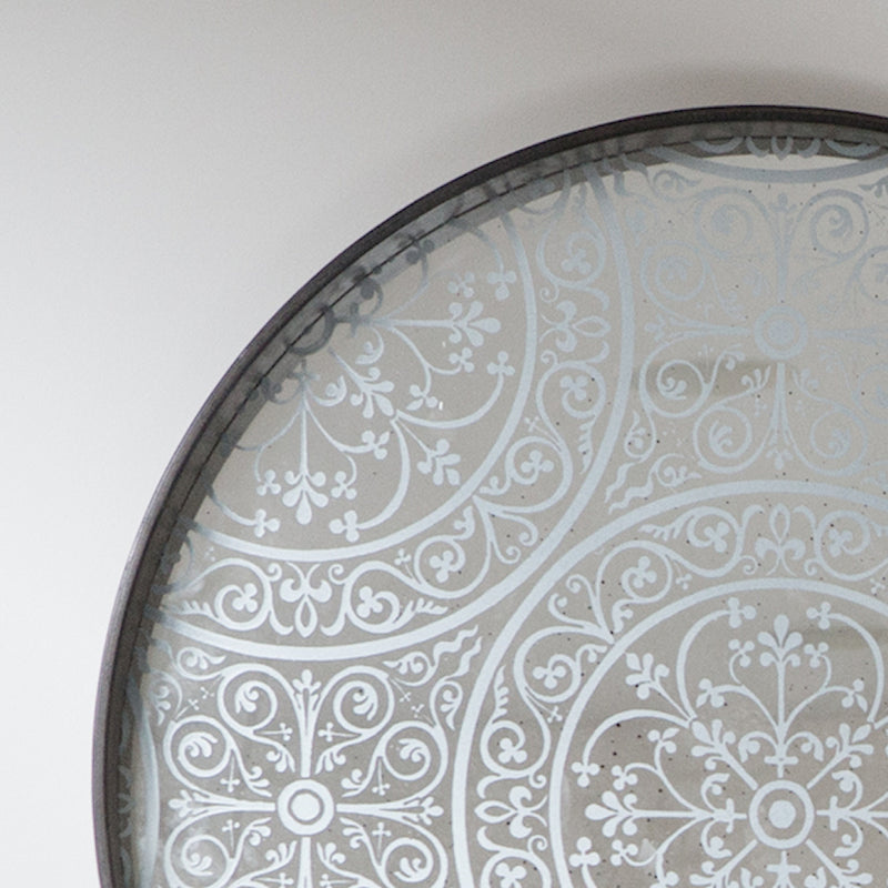 Moroccan  detail - repeat pattern over aged mirror.