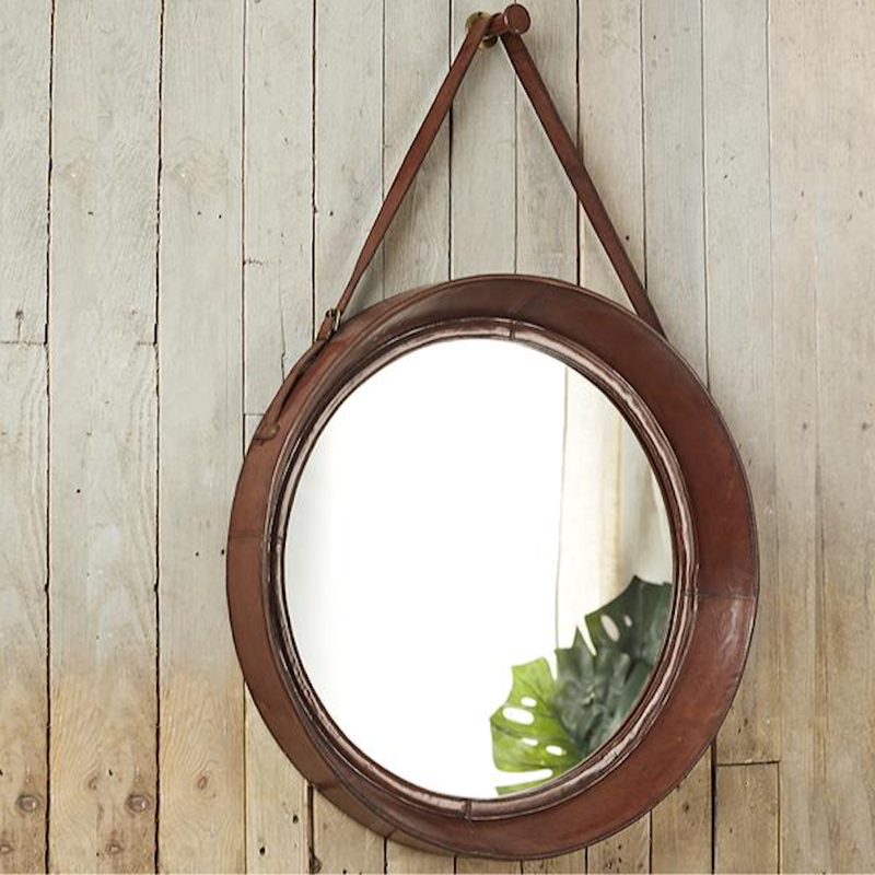 Leather Rimmed Wall Mirror with leather strap hanging from a leather covered peg.