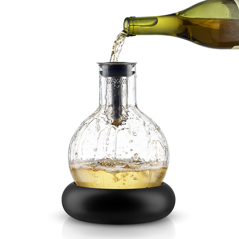 Cool decanter shown with white wine being poured into top.