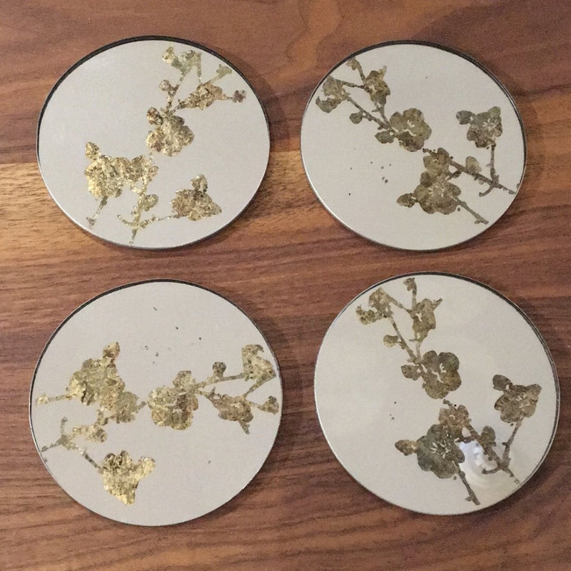set of four blossom coasters on walnut tabletop