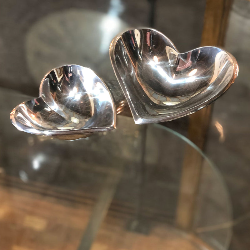 silver aluminium smooth dishes shaped like hearts.