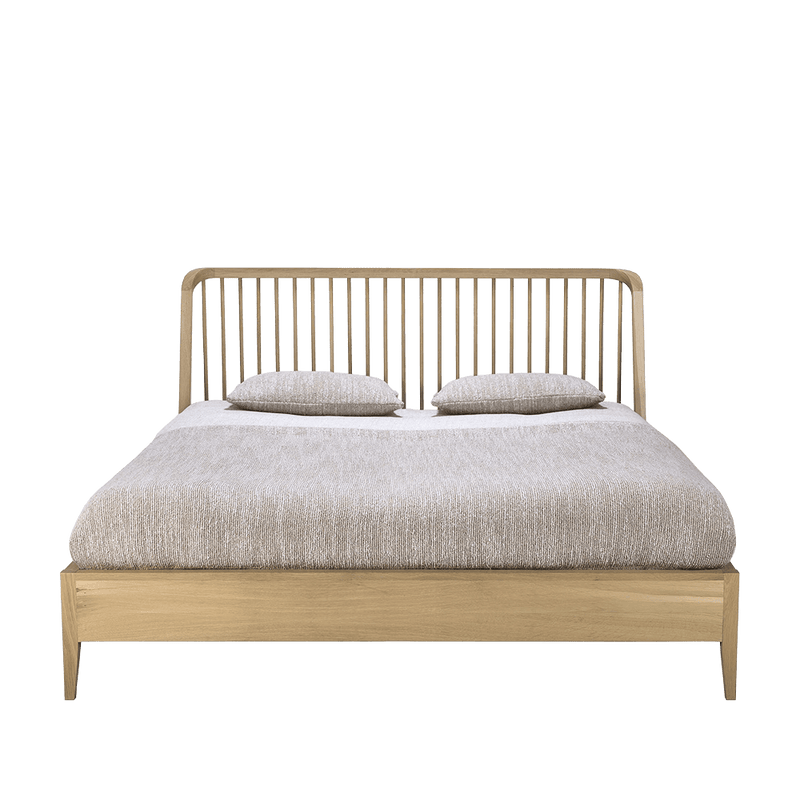 oak bed with spindle style headboard with mattress and cushions