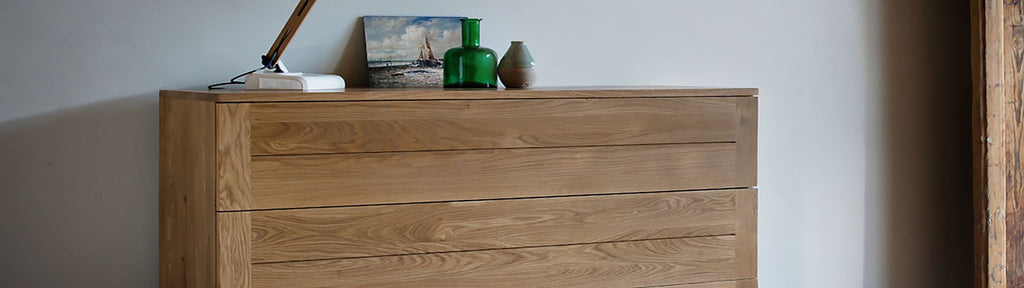 Oak Chest of drawers with modern lamp and collection of objects