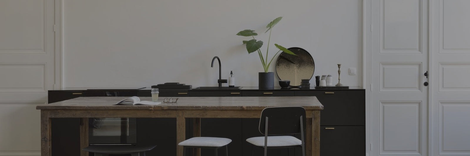 long kitchen table with chairs in front of vintage kitchen