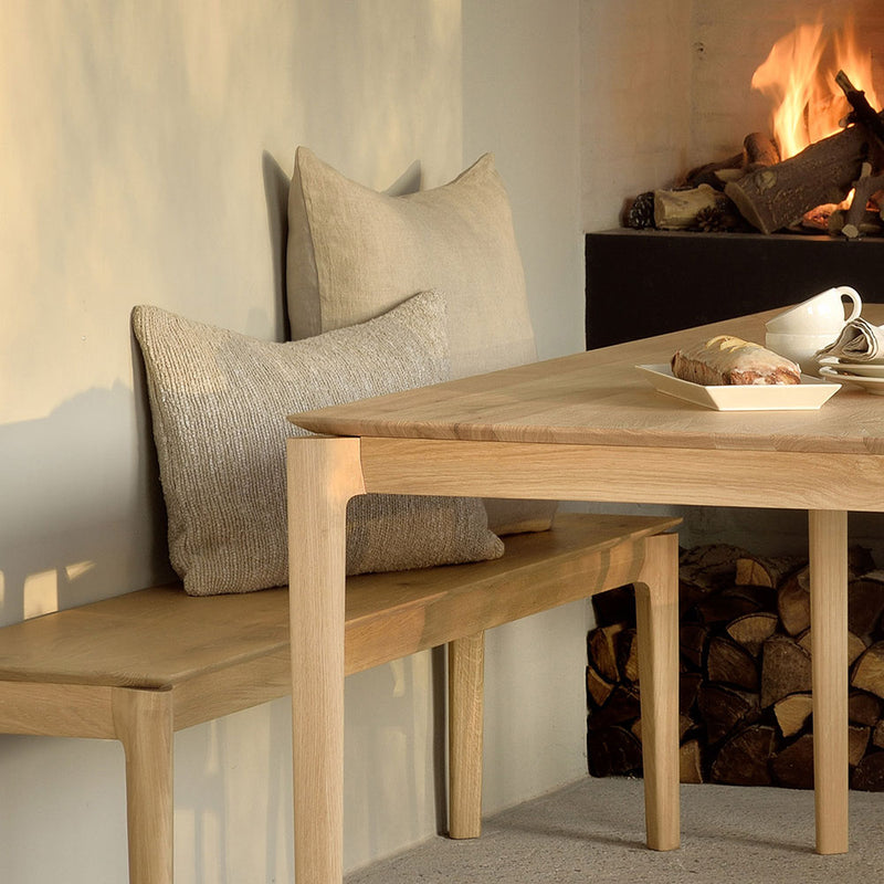 bruges oak dining table and bench with logs burning in background