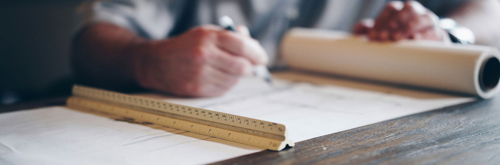 drawing out a design on paper.