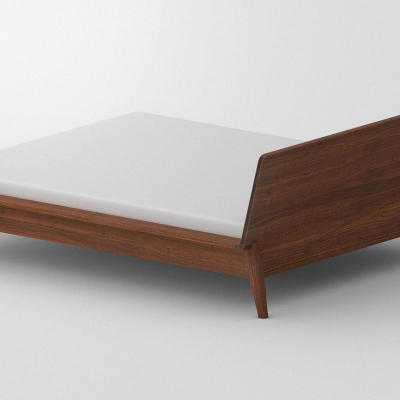 Back view of solid walnut double bed with white mattress