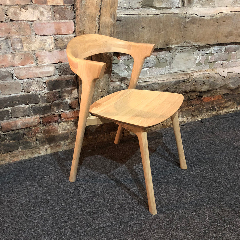 Luca oak dining chair against old brick wall 