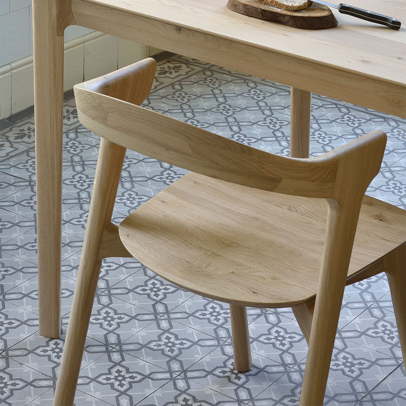 Luca solid oak chair shown under table 