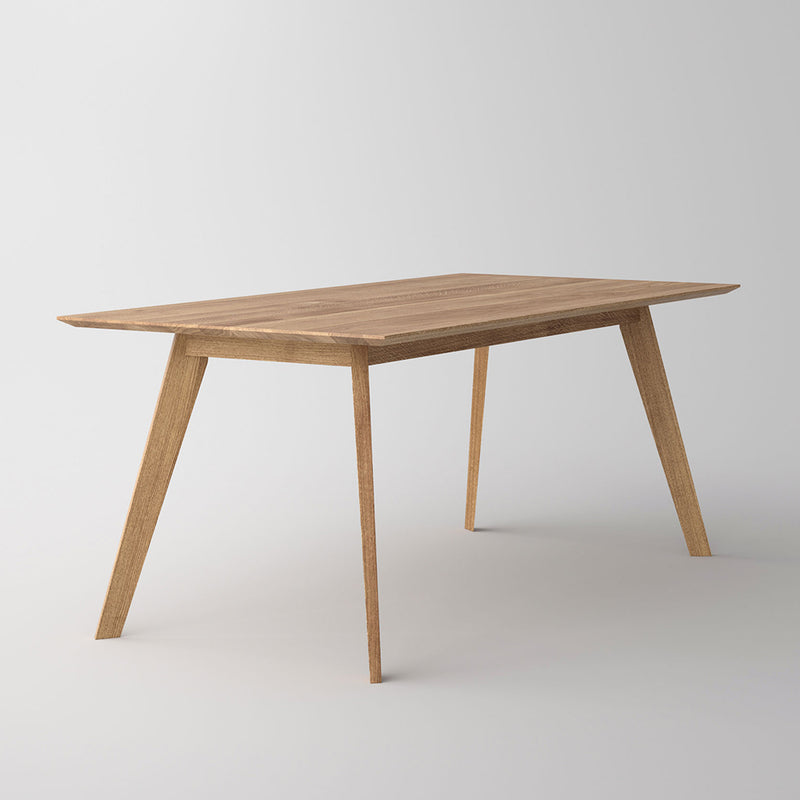 Citie dining table , tapered edge and angled legs in a natural oil finish