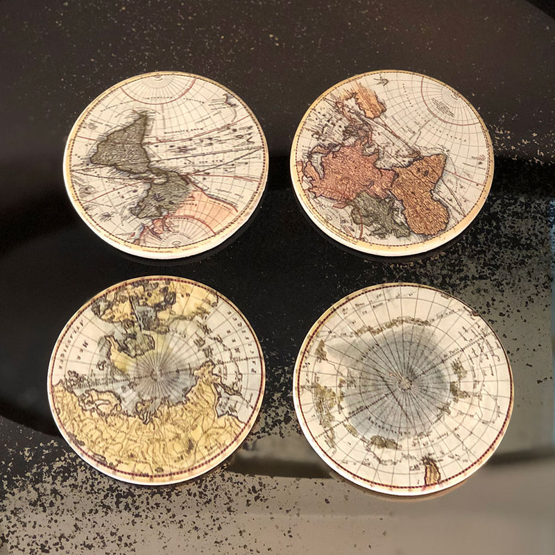 four round coasters each with a different image of an old map, sepia colours