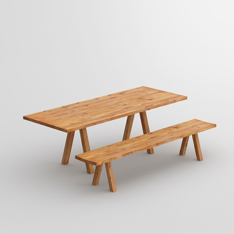 Facile oak table with trestle style legs finished in natural oil - shown with matching bench