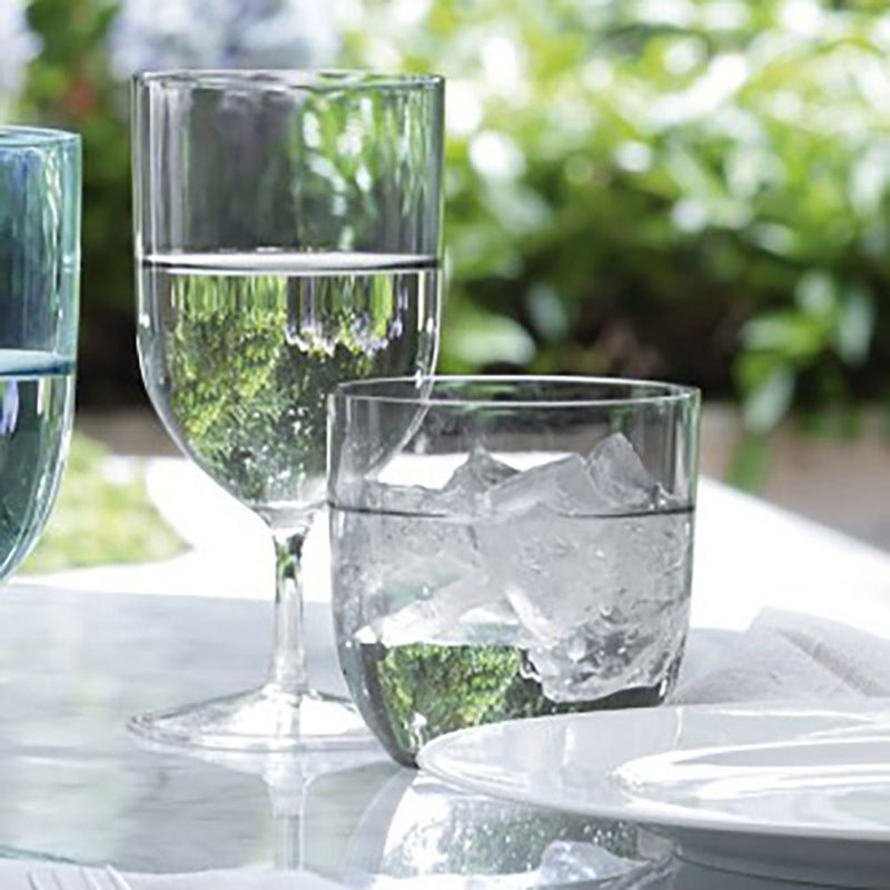hint grey glass wine and tumbler glasses set on an outside dining table