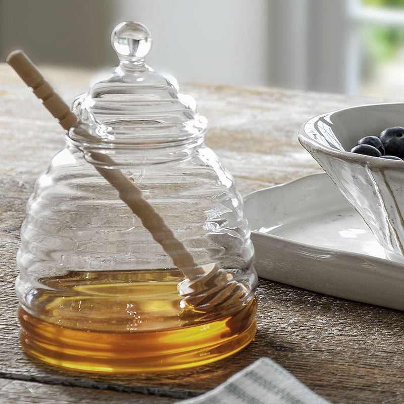 glass honey pot shaped jar, with beech wood dibber, shown with honey inside