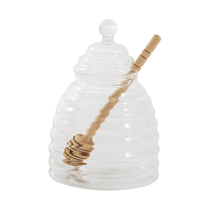 empty glass honey pot showing dibber through the hole between lid and base.