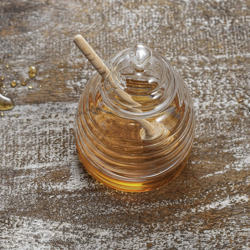 top view of glass honey pot, glass lid has a round handle