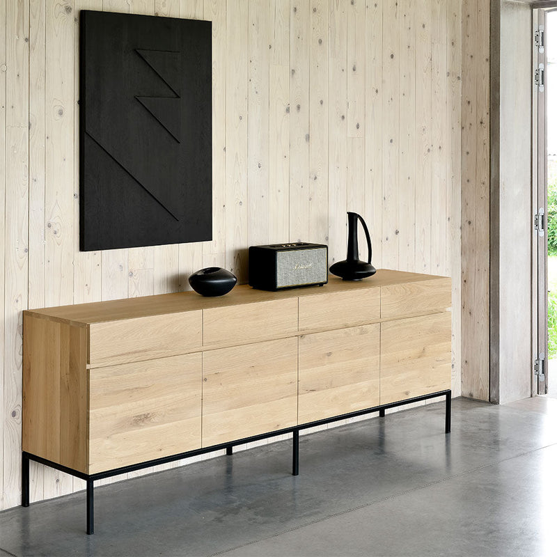 L1 sideboard showing flat front, grain continuous piece along all door fronts. 2 door option shown with black metal leg in modern living room setting.