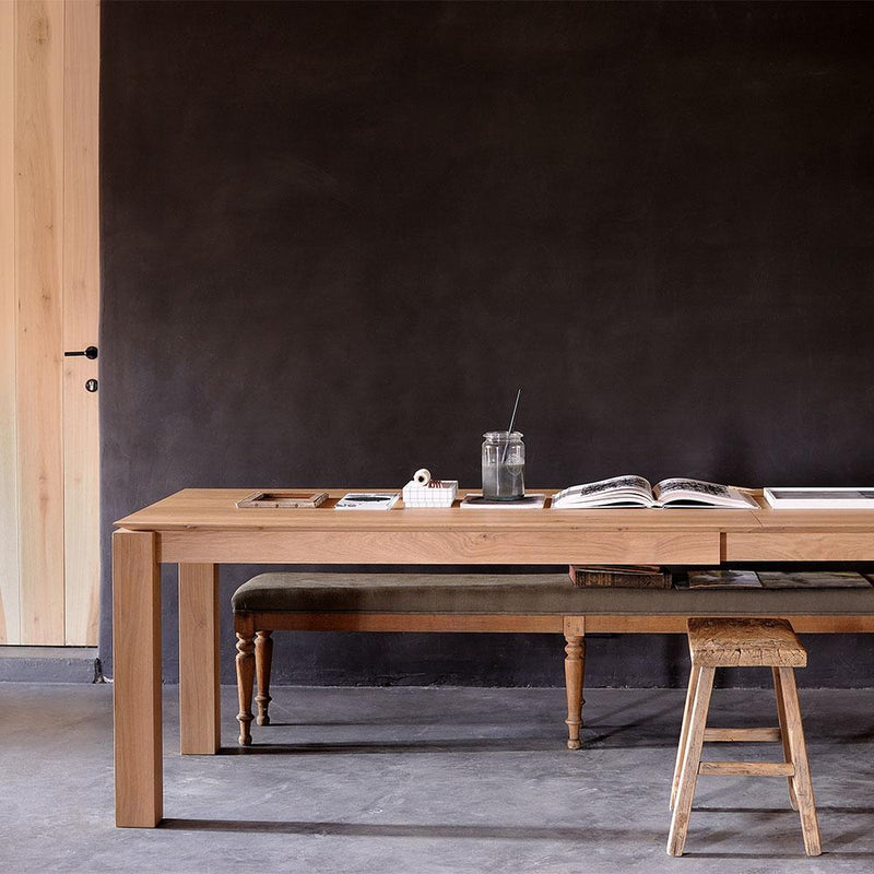 Oak Planar extending table shown in modern dining space with  bench and stool seating.