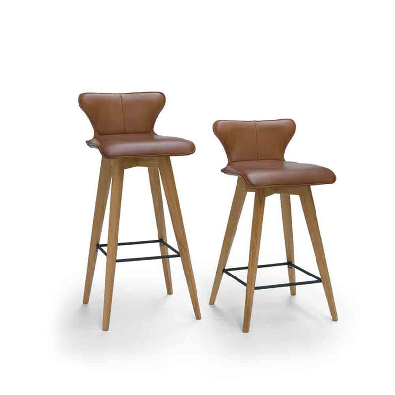 L1 barstool with oak legs and black footrest, leather seat shown in brown, shown in both mid and high .