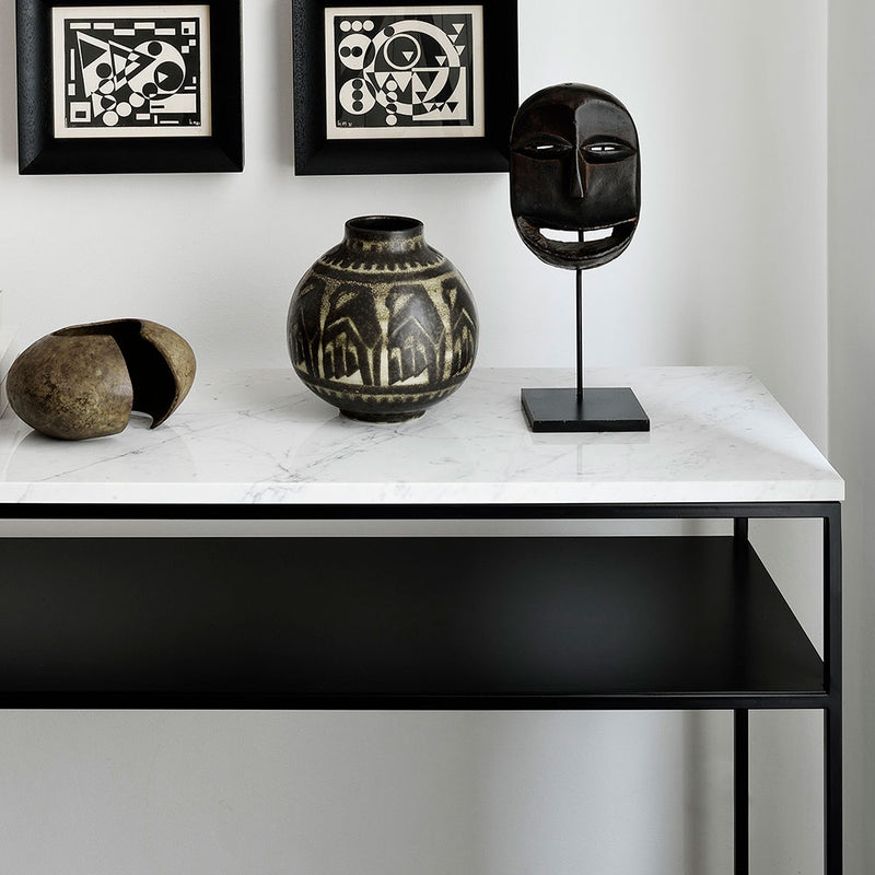 stone white marble top console table with black frame and shelf. shown in contemporary home setting