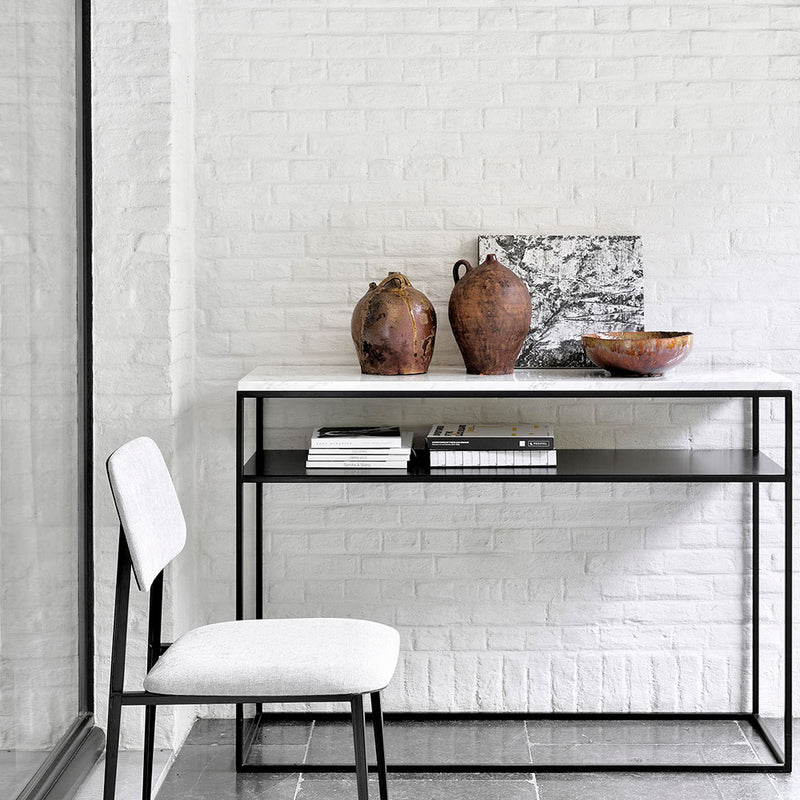 stone top console table with black frame and shelf. shown in contemporary home setting
