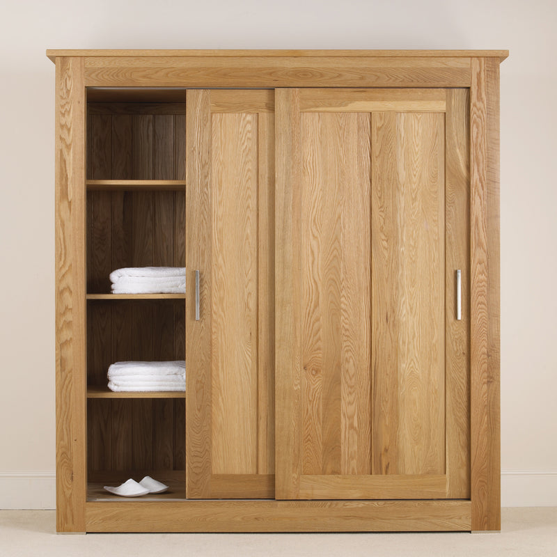 interrior of oak sliding door wardrobe showing optional oak internal shelves