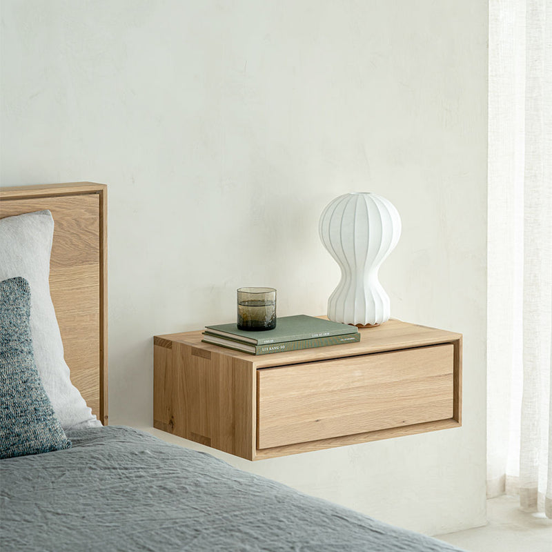 wall hanging bedside cabinet next to solid oak contemporary bed