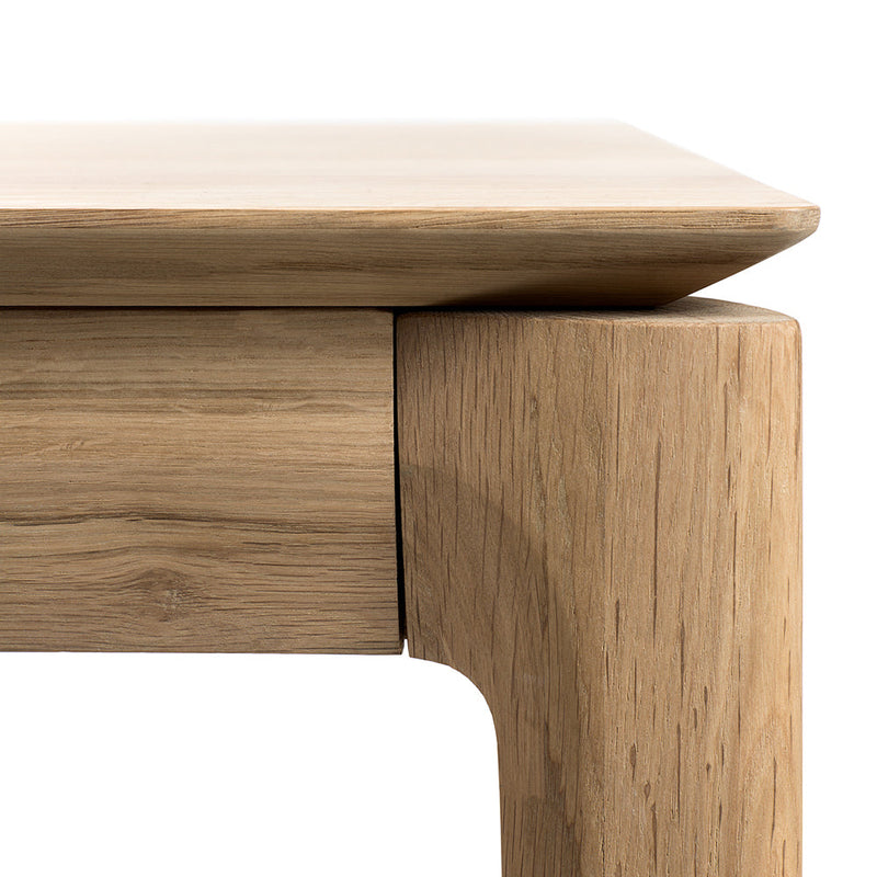 B1 oak table detail of corners, tapered edge to wood top,over rounded legs.