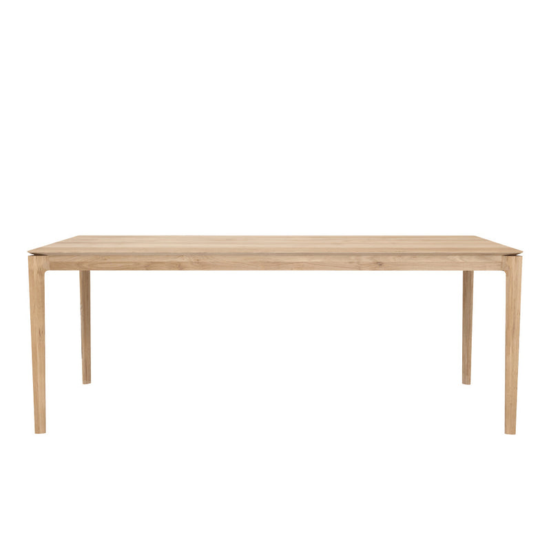 B1 oak fixed dining table , tapered edge to wood top,over rounded legs.