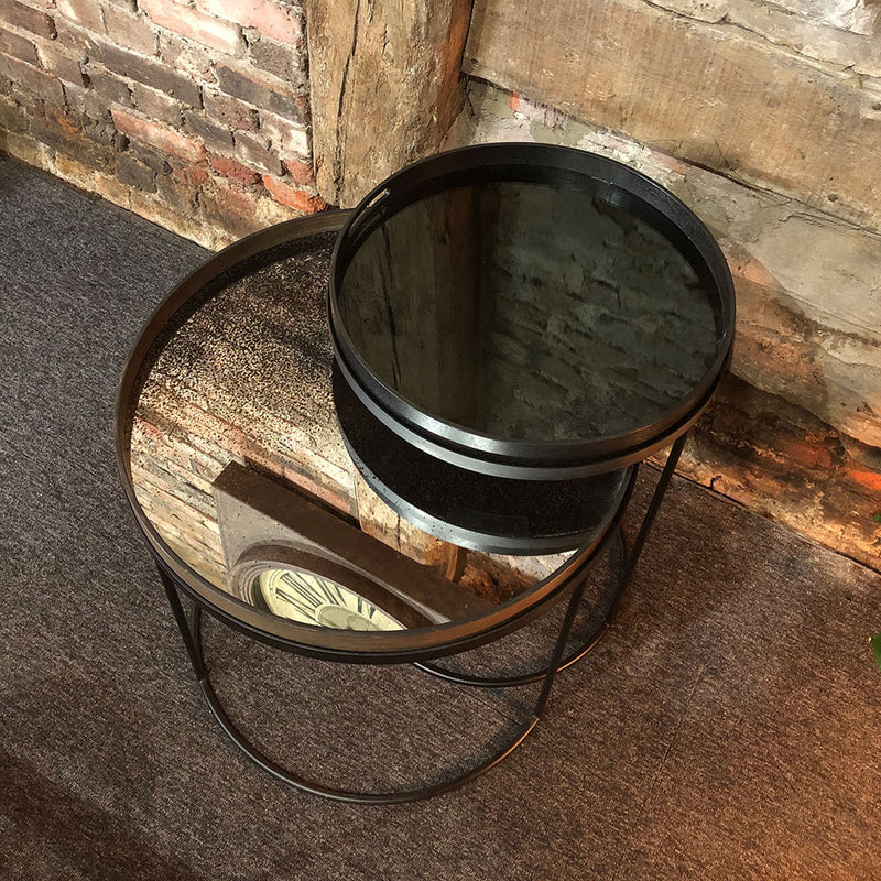 small charcoal tray and large heavy aged tray on top of stackable side table tray tables.