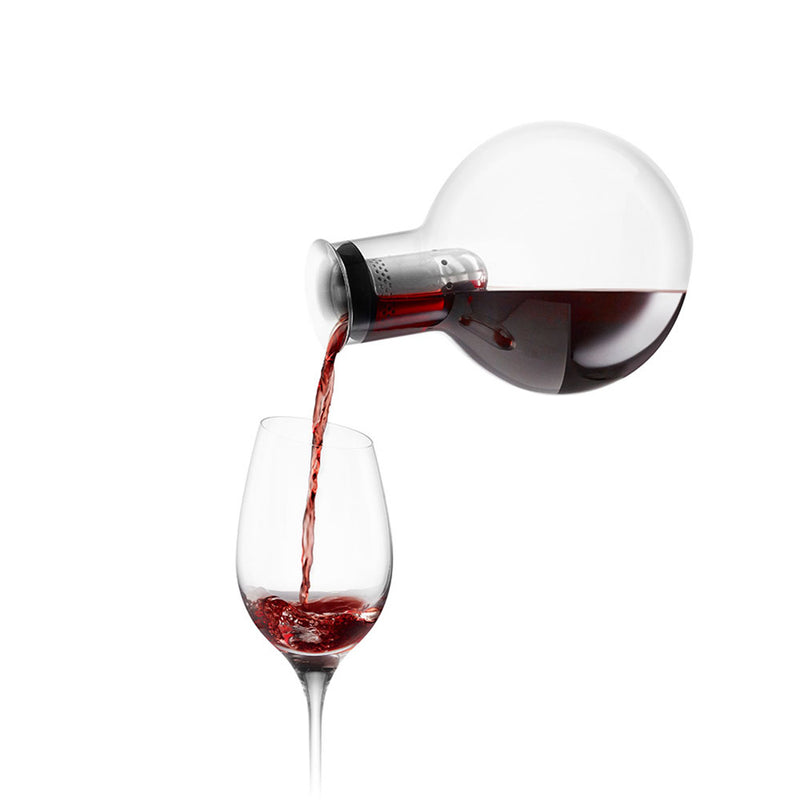 Cool decanter shown with red wine being decanted into a wine glass.