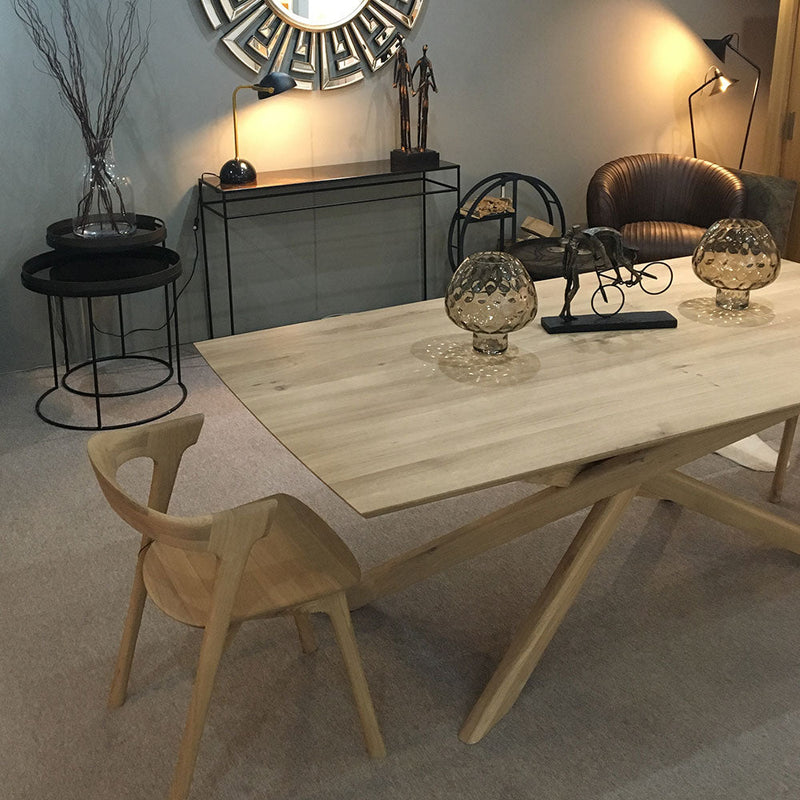 Elements rectangle oak dining table shown with wood B1 chair in a contemporary room setting.