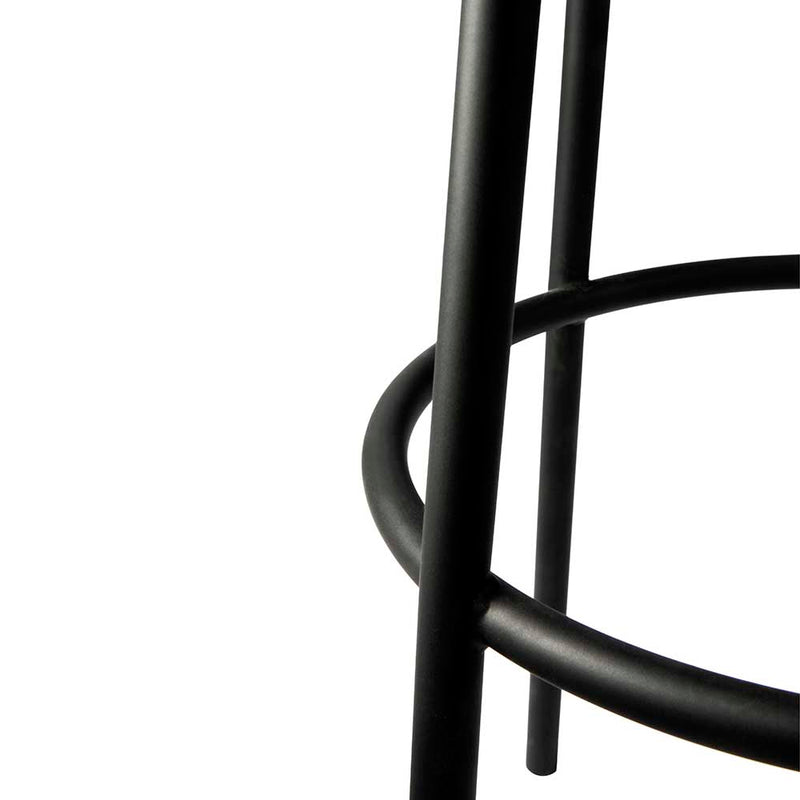 detail of black rounded metal leg frame and foot rest.