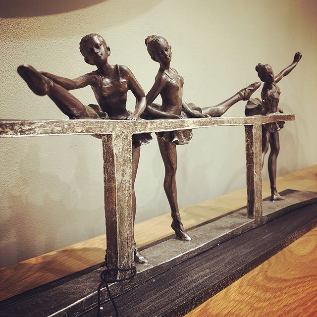 Beautiful sculpture , a trio of young ballerinas at the barre-close up
