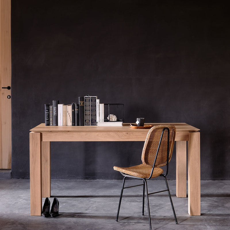 Oak-Planar-Dining-Table-Lifestyle styled with books and a chair as a desk in a modern home office 
