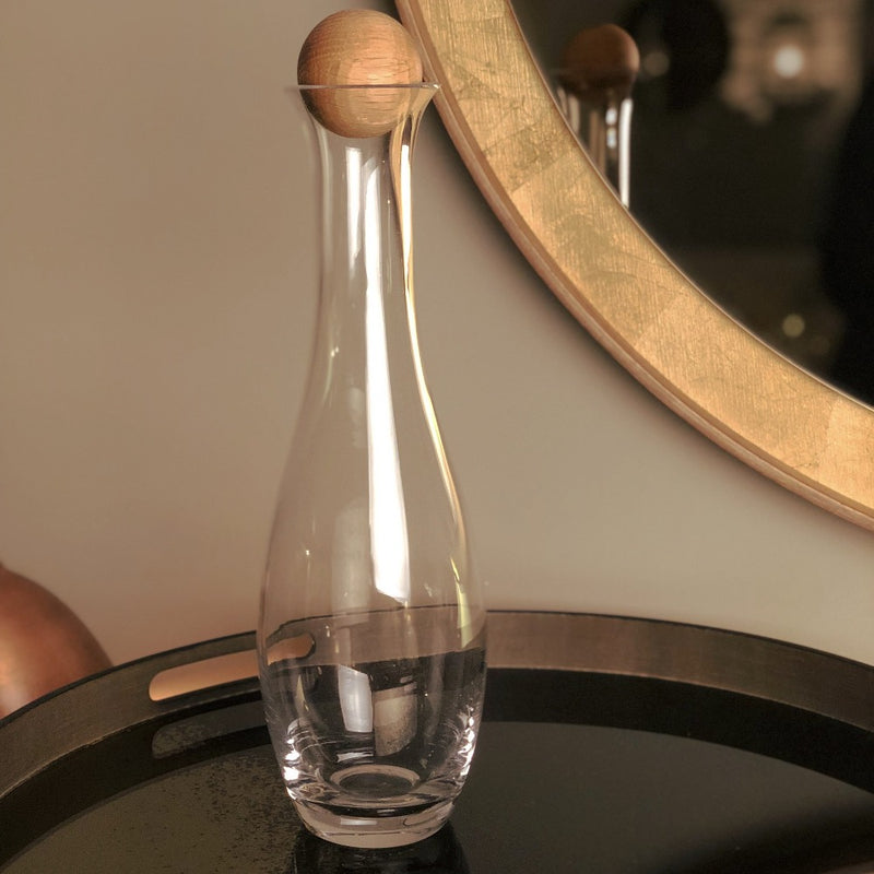 glass tall water carafe with oak ball shaped stopper.