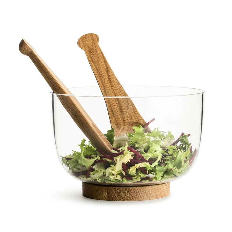 glass salad bowl, with salad servers showing. 
