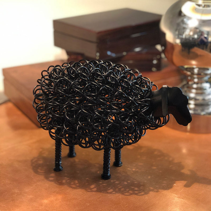  close up image of black wired Sheep displayed on table